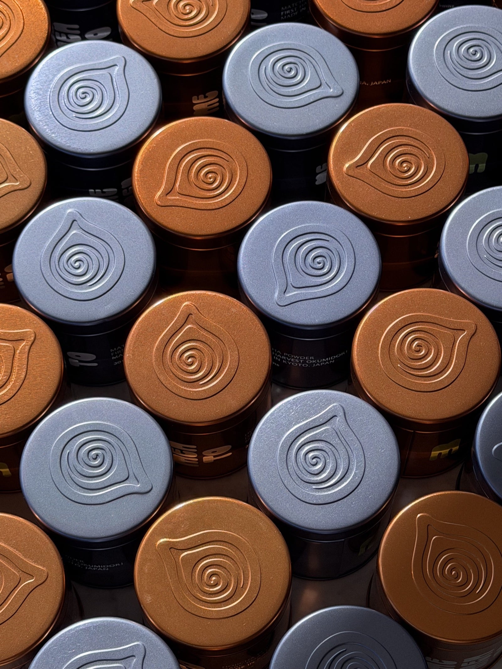 Embossed swirl lids on Memento Matcha tins